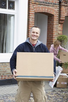 Removal crew loading boxes into a moving van