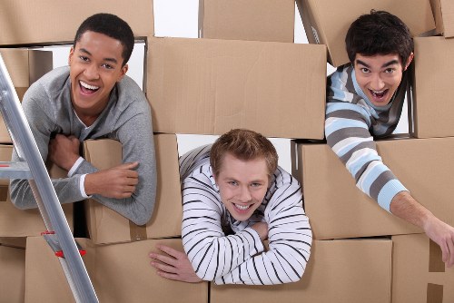 Furniture and boxes being loaded into a moving van in Swiss Cottage