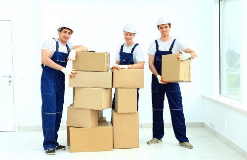 Removalists handling boxes and furniture in a Swiss Cottage flat
