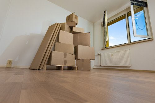 Trained removals staff carrying boxes with care