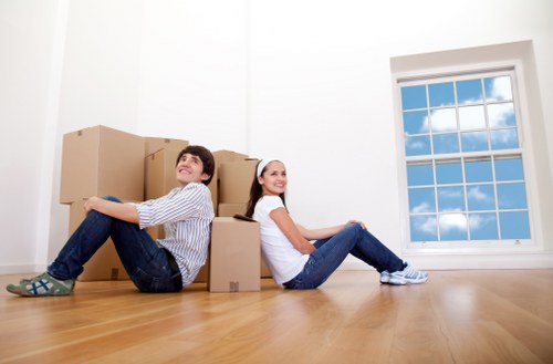 Moving equipment and wrapped furniture prepared for safe transport in Swiss Cottage