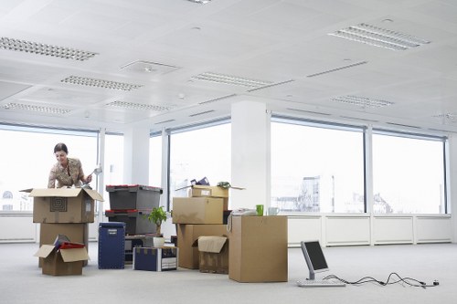 Professional movers handling household items in a London flat